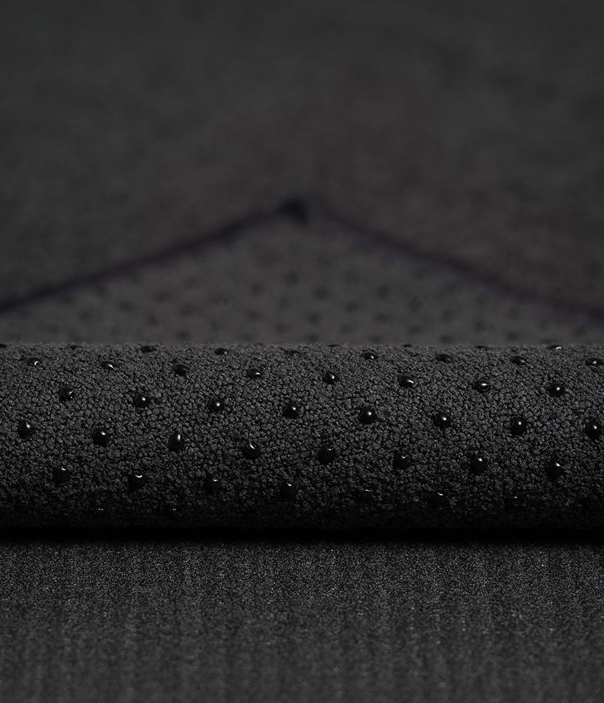 Manduka Yogitoes Mat Towel - Onyx - corner folded over showing underside | Manduka NZ