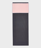Manduka eQua Hand Towel - Coral - placed on a yoga mat | Manduka NZ