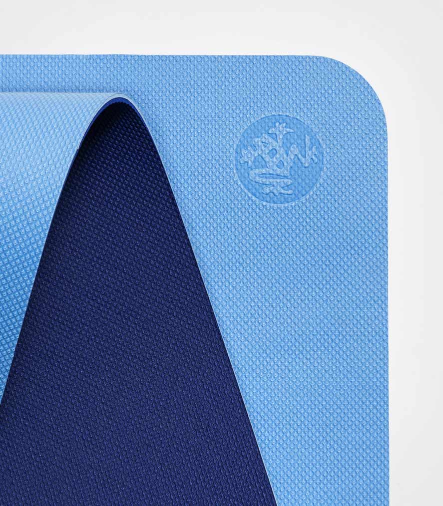 Manduka Begin Mat 5mm Yoga Mat - Light Blue - top corner loosely rolled showing both sides | Manduka NZ